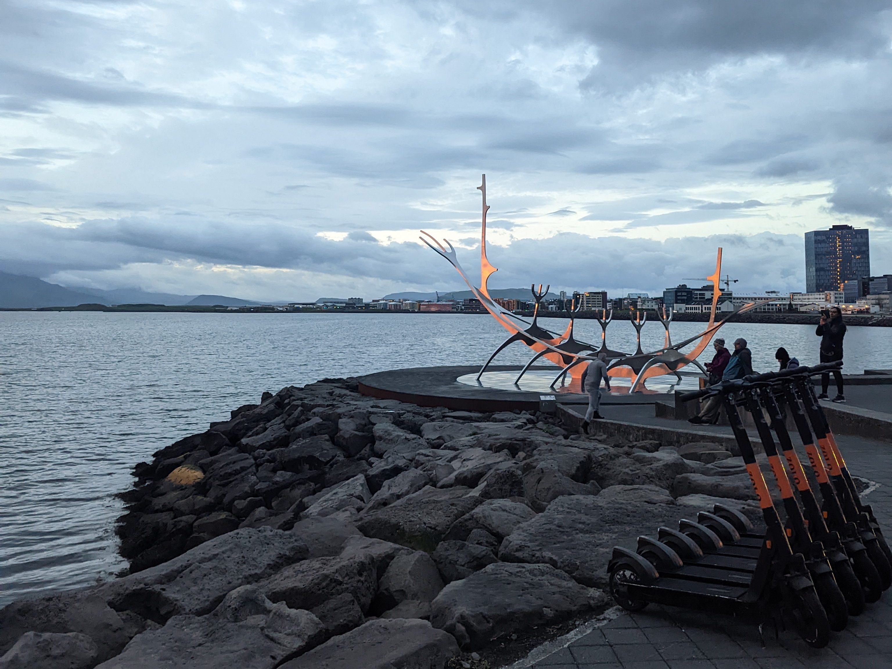 The glowing Sun Voyager sculpture in Reykjavik, Iceland during the midnight sunset