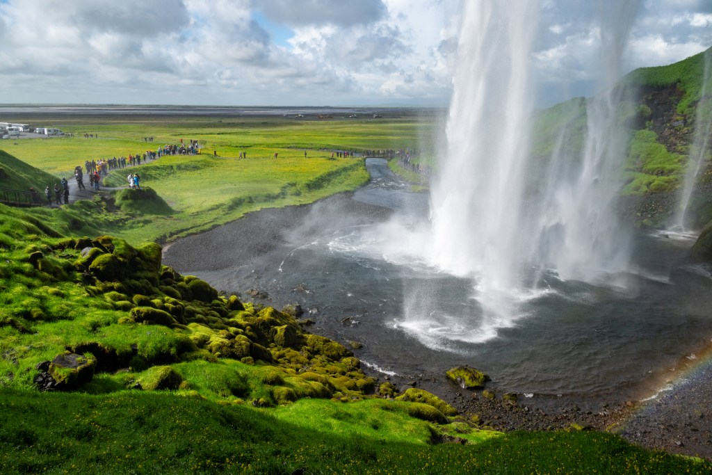 Behind Seljalandsfoss in Iceland on a sunny day